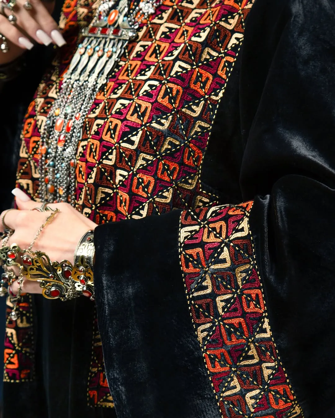 Black velvet robe with geometric hand-embroidery — atelier detail
